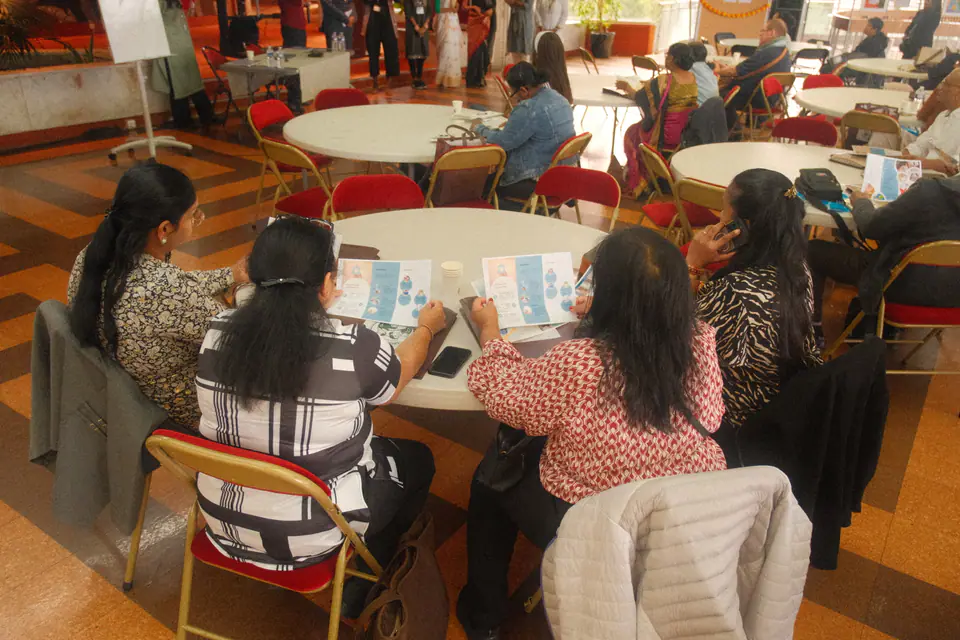 Participants read information leaflets around a table